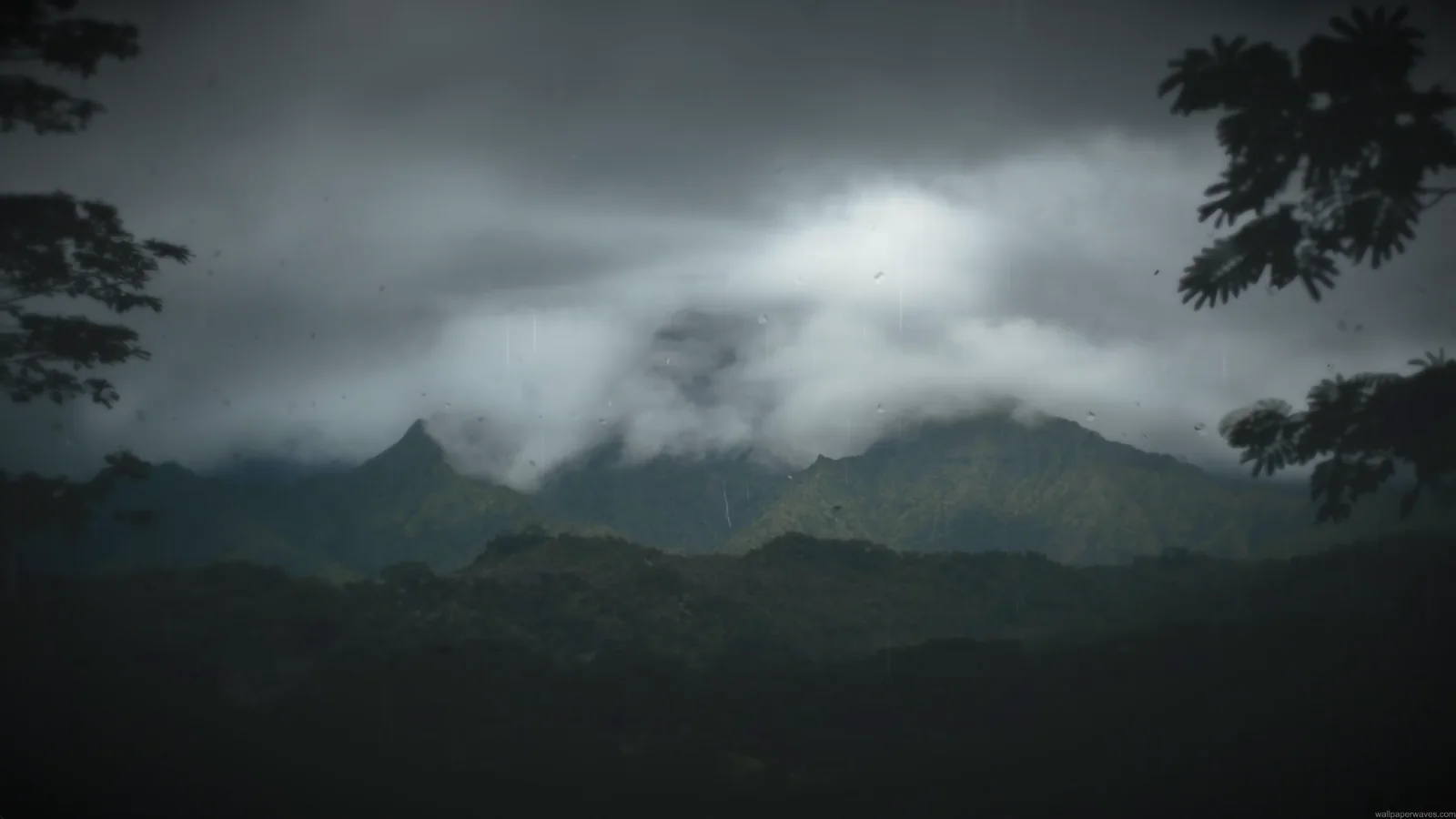 Rainy mountain valley beneath dark clouds