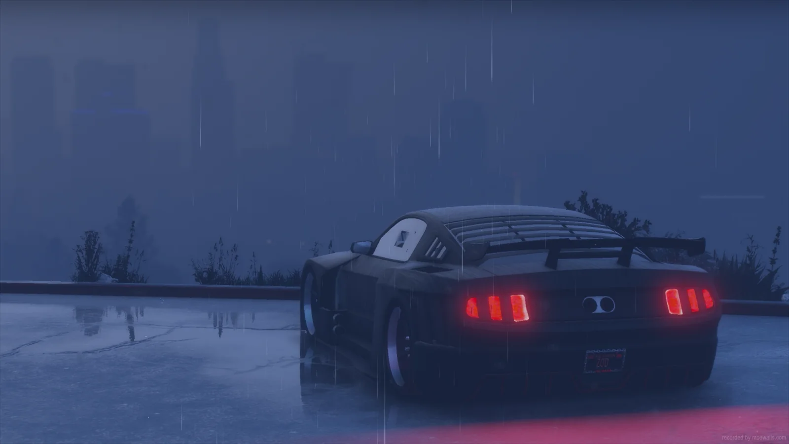 Rear of a dark Ford GT with red taillights in blue mist