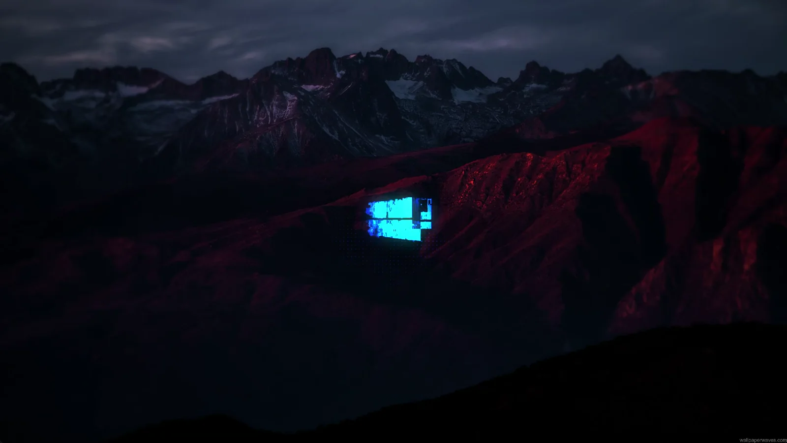 Glowing Windows logo above a dark mountain ridge at night